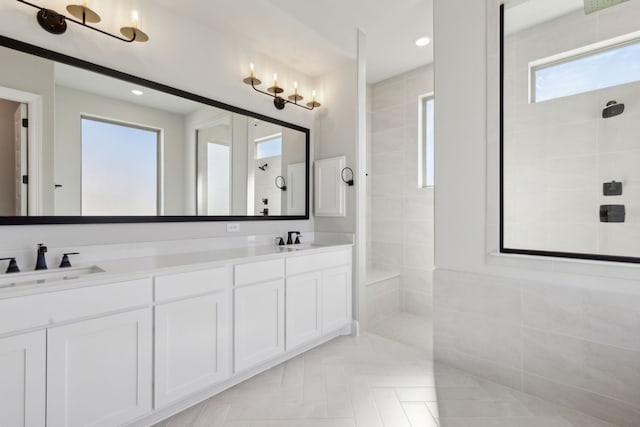 full bath featuring double vanity, walk in shower, a sink, and recessed lighting