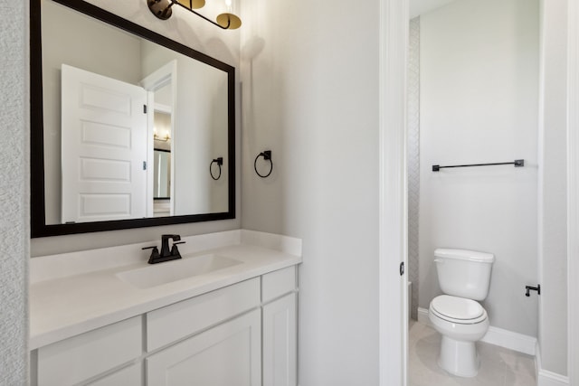 bathroom with tile patterned floors, vanity, and toilet