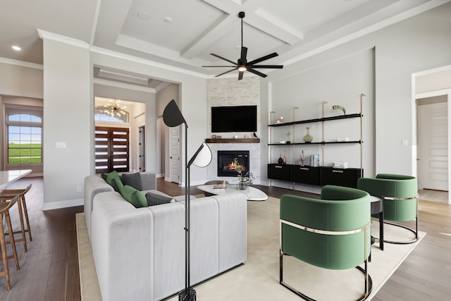 living room with a fireplace, wood finished floors, coffered ceiling, baseboards, and beamed ceiling