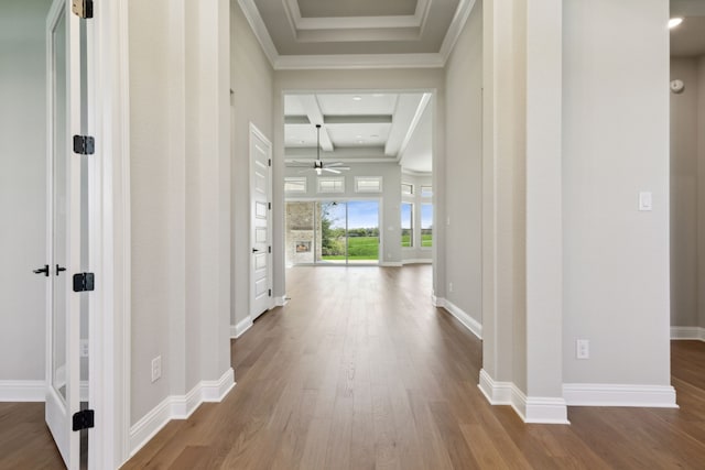 corridor featuring beamed ceiling, hardwood / wood-style flooring, crown molding, and coffered ceiling