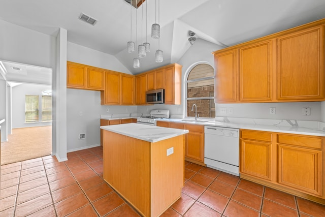 kitchen featuring lofted ceiling, a center island, a healthy amount of sunlight, and white appliances