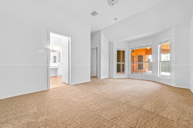 unfurnished living room featuring light colored carpet