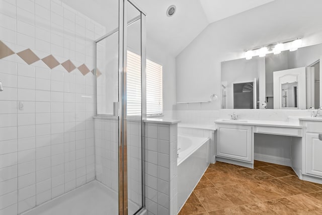 bathroom with tile patterned floors, separate shower and tub, vanity, and lofted ceiling