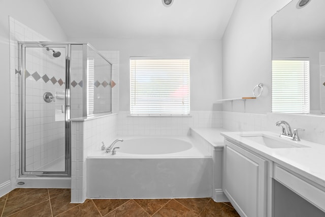 bathroom featuring plus walk in shower, tile patterned floors, vanity, and lofted ceiling