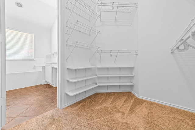 spacious closet featuring light tile patterned flooring