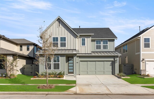 view of front of property featuring a front lawn and a garage