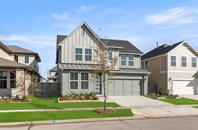 view of front of property with a front yard and a garage