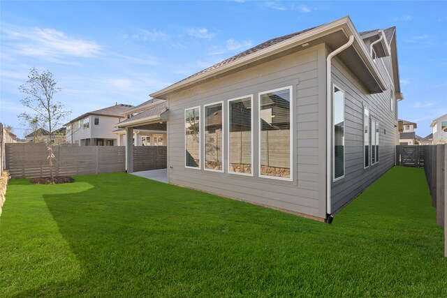 rear view of property with a patio and a lawn