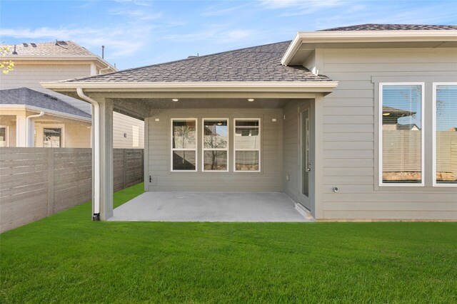 rear view of house featuring a patio and a lawn