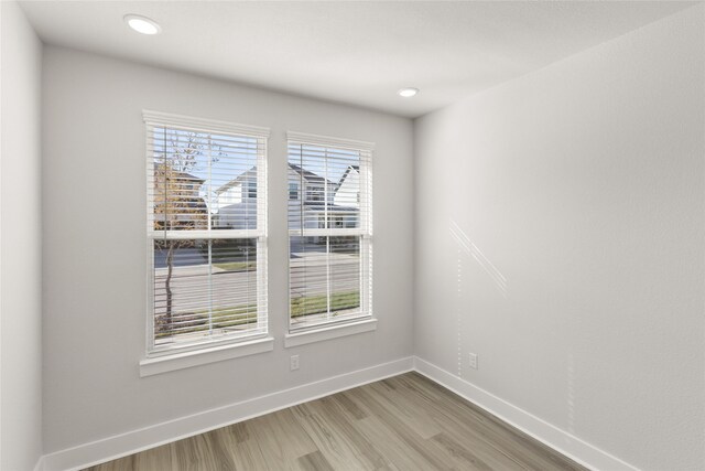 unfurnished room with wood-type flooring