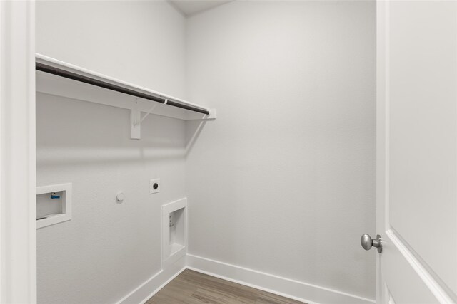 washroom featuring washer hookup, wood-type flooring, hookup for an electric dryer, and gas dryer hookup