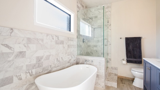 full bathroom featuring toilet, independent shower and bath, vanity, and wood-type flooring