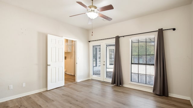 empty room with french doors, hardwood / wood-style floors, and ceiling fan