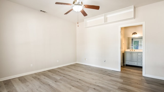 empty room with ceiling fan, wood-type flooring, and sink