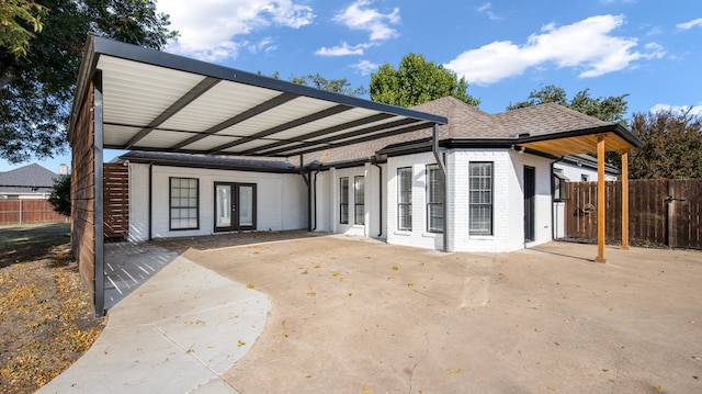 view of front of property with a carport and french doors