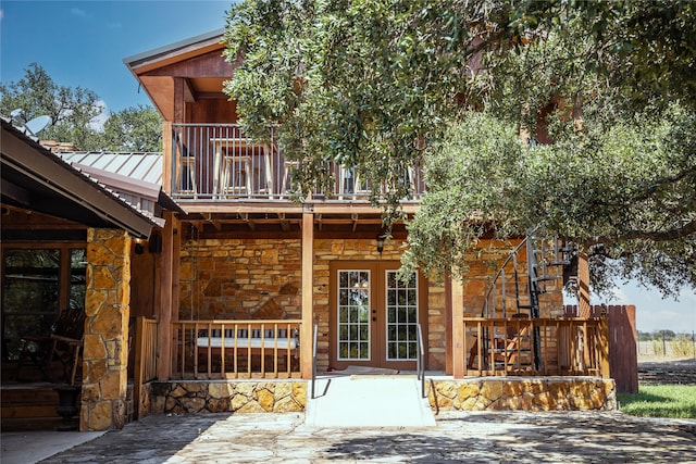 exterior space with a balcony, a patio, and french doors