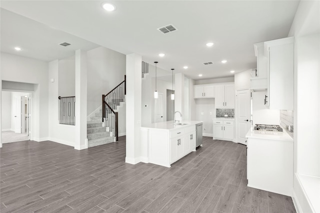 kitchen with light hardwood / wood-style flooring, sink, stainless steel appliances, and white cabinets