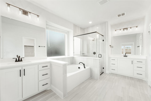 bathroom with separate shower and tub and vanity