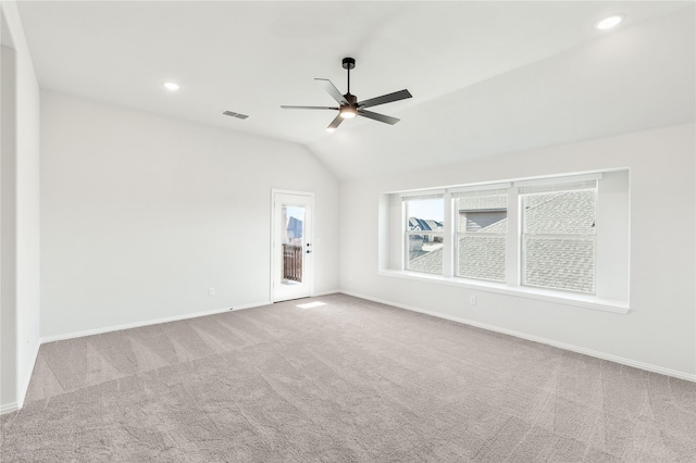 carpeted spare room with vaulted ceiling and ceiling fan