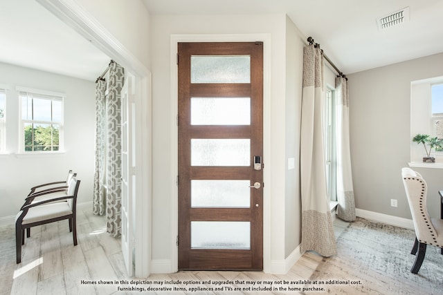 foyer entrance with light wood-type flooring