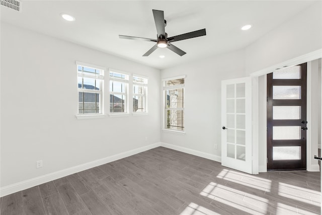 spare room with hardwood / wood-style flooring and ceiling fan