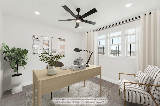 home office with ceiling fan and dark wood-type flooring