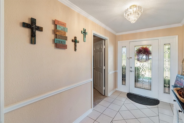 entrance foyer featuring an inviting chandelier, light tile patterned floors, and crown molding