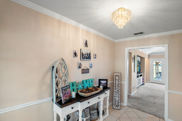 hall with a notable chandelier, light colored carpet, crown molding, and a textured ceiling