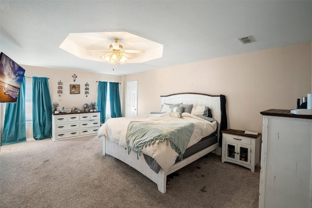 bedroom with carpet, visible vents, a skylight, and ceiling fan