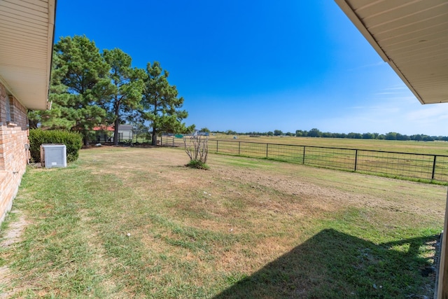 view of yard featuring a rural view and a fenced backyard