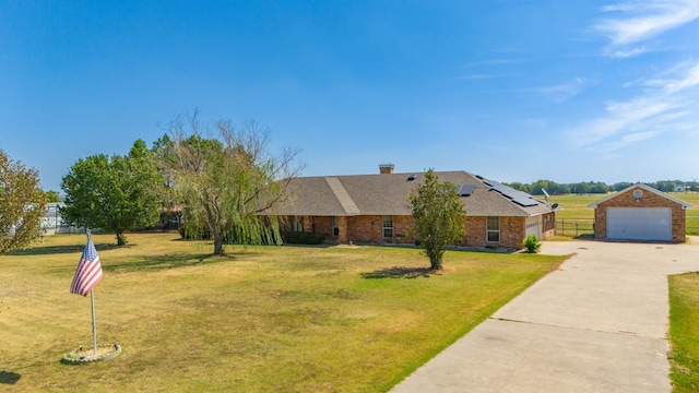 ranch-style house with a chimney, a front lawn, a garage, solar panels, and brick siding