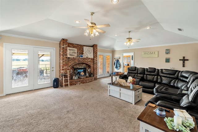 living area featuring light carpet, visible vents, lofted ceiling, a ceiling fan, and a fireplace