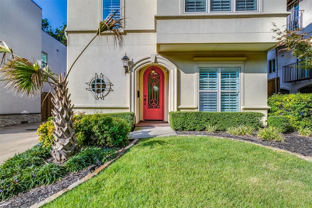 doorway to property featuring a lawn