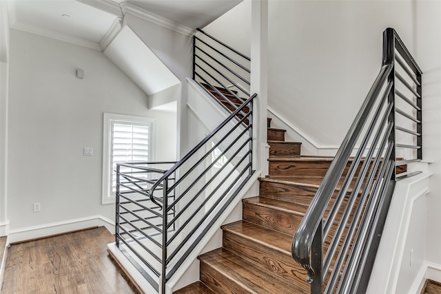 stairway featuring crown molding and wood-type flooring