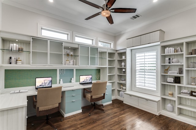 office space with crown molding, dark hardwood / wood-style floors, built in desk, and a wealth of natural light