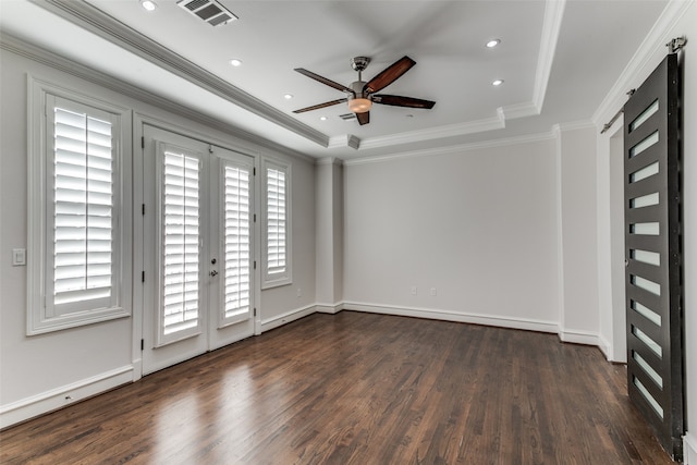 unfurnished room featuring dark wood-type flooring, crown molding, and a tray ceiling