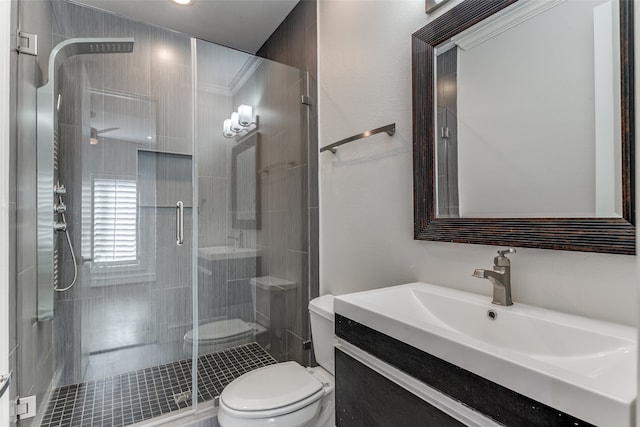 bathroom with vanity, toilet, and an enclosed shower