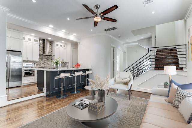 living room featuring ornamental molding, ceiling fan, and dark hardwood / wood-style flooring