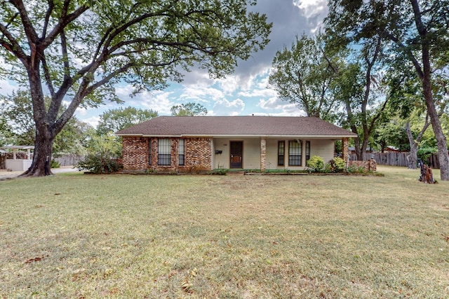 ranch-style house featuring a front lawn, fence, and brick siding