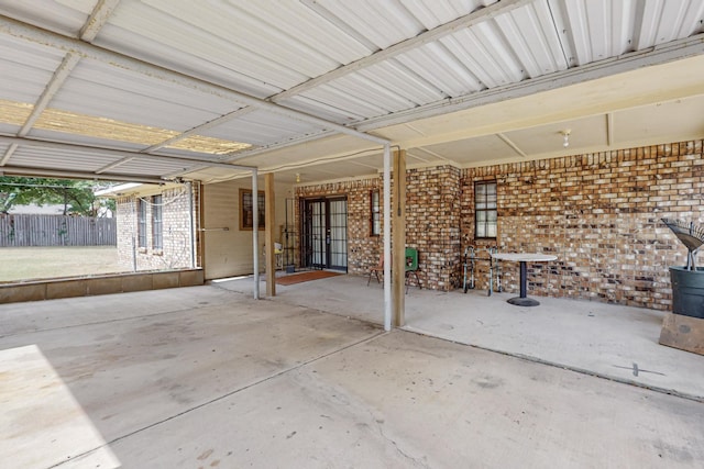 view of patio featuring french doors and fence