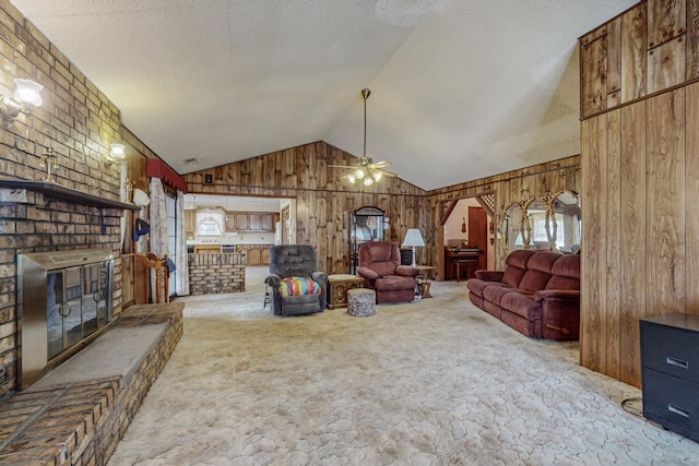 living area with lofted ceiling, a brick fireplace, light colored carpet, and wood walls