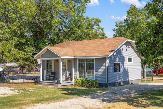 view of front of property featuring covered porch and a front yard