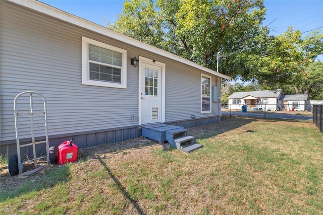 entrance to property featuring a yard