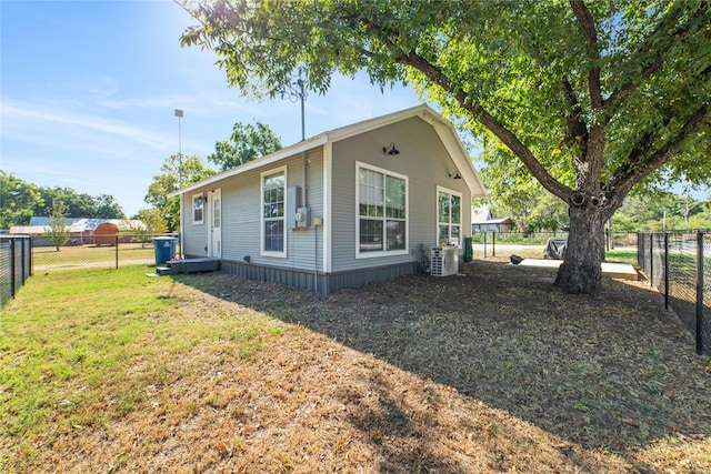 view of side of home featuring central air condition unit and a lawn