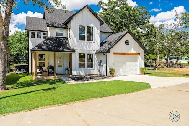 modern farmhouse with a front yard, a porch, and a garage