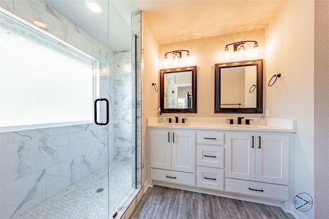 bathroom with a shower with door, wood-type flooring, and vanity