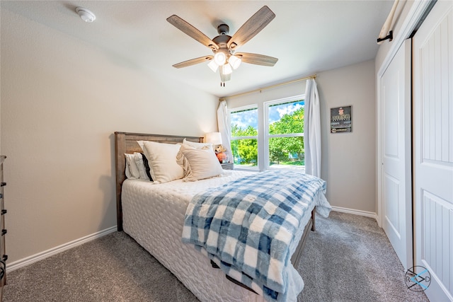 bedroom with dark carpet, a closet, and ceiling fan