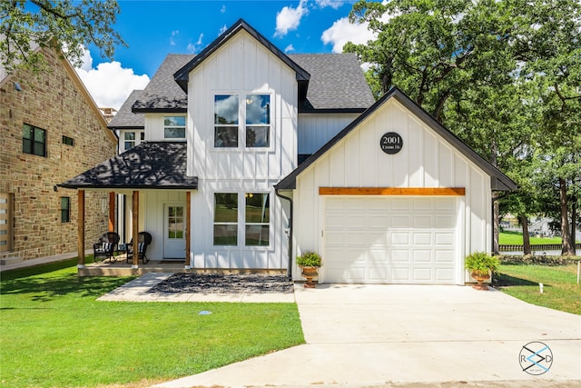 modern farmhouse featuring a porch, a garage, and a front lawn