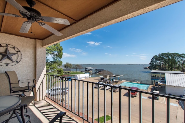 balcony with a water view and ceiling fan