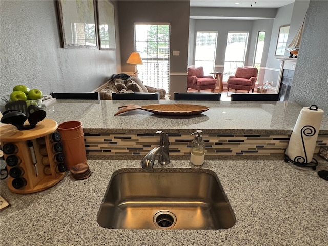 interior space featuring sink and light stone countertops